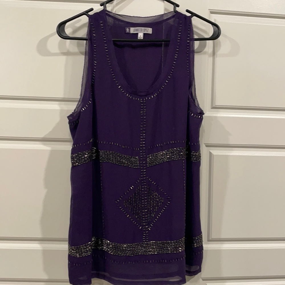 Purple tank top with black sequins. 100% polyester. Barely worn